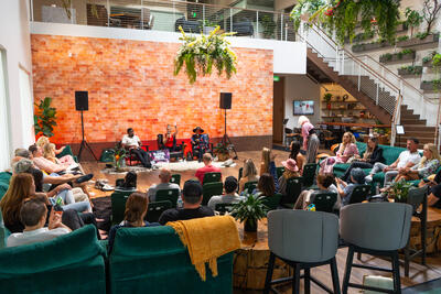 Wide shot of the stunning salt wall venue at Day of Biohacking Love with audience seated in the round