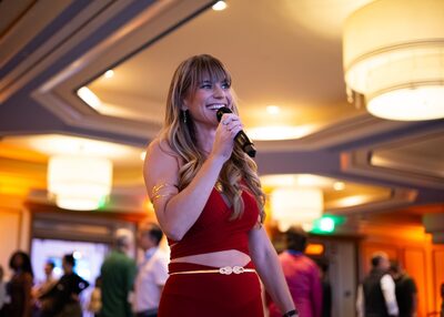 Close-up of Christina Weber emceeing with microphone at Beyond Biohacking Conference