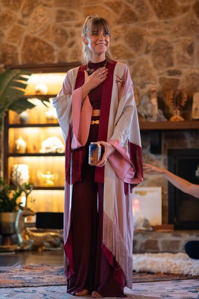 Christina Weber in a ceremonial shawl with hand on heart