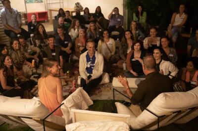 Christina Weber hosting a packed Dating Dojo event in Venice with a full crowd outdoors